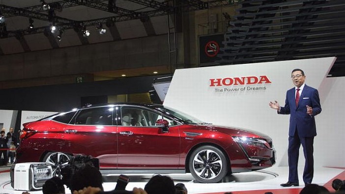 Honda Motor Co Ltd president and CEO Takahiro Hachigo with the hydrogen-powered Clarity FCV (fuel cell vehicle) at the 2015 Tokyo Motor Show.